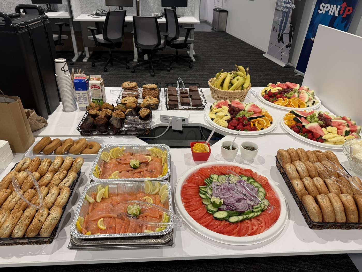 Boardroom table set with catering trays and lunch platters