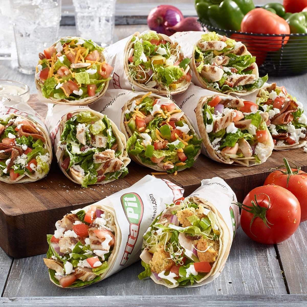 Box of wrapped pitas with mixed fillings